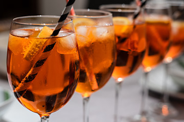 Cocktail with ice and straw. Full glasses ready for the party. 