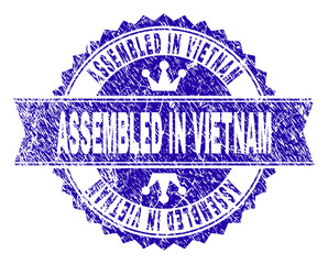 ASSEMBLED IN VIETNAM rosette stamp overlay with grunge style. Designed with round rosette, ribbon and small crowns. Blue vector rubber watermark of ASSEMBLED IN VIETNAM tag with retro style.