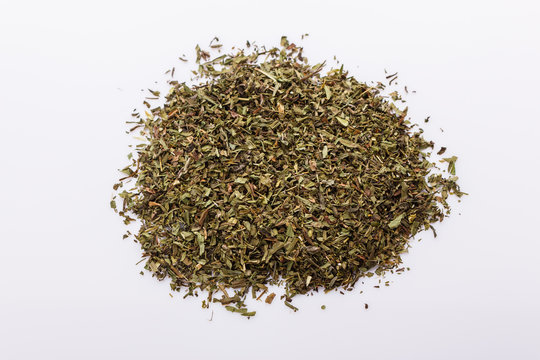 dried tarragon and essential oil on a white background