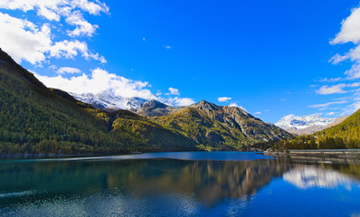 Fototapeta na wymiar Lake of Ceresole Reale, near the Nivolet pass, clear autumn morning, blue sky, Piedmont, Italy
