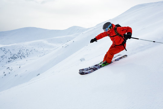 A Man Is Skiing On The Slope.