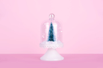Creative Christmas design on pink pastel color background with Christmas tree.