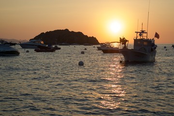 fishing boat at sunset in Mediterranean Sea. Unprocessed photo