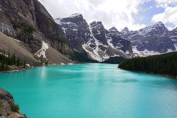 The Moraine lake with snow-covered rocky mountains in Banff National Park of Canada.