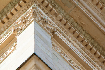 Fototapeta premium part of the classical façade of a beige historical building with a relief
