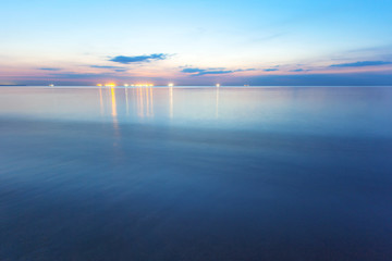 landscape at dusk, smooth sea surface during the 