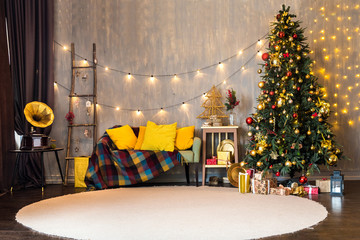 Funny colorful room with christmas interior, Xmas Tree decorated. Color decor with sofa and pillows