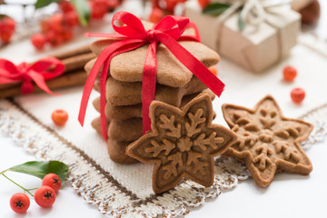 Fototapeta na wymiar Element of Christmas decoration on the napkin for your design. Christmas cookies, gingerbread handmade in the shape of stars with red ribbon. Top view