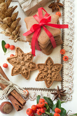 Element of Christmas decoration on the napkin for your design. Christmas cookies, gingerbread handmade in the shape of stars with red ribbon. Top view