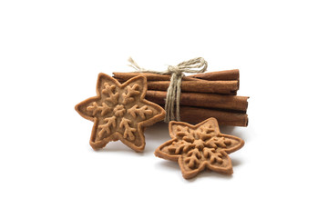 Christmas cookies handmade and cinnamon sticks on a white backgroun. Top view