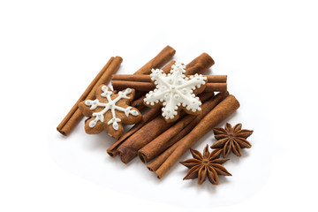 Christmas spices and stars still life with delicious star-shaped cookies, cinnamon sticks and star anise on a white backgroun. Top view
