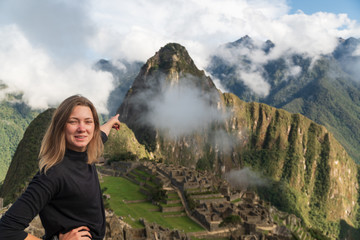 Pointing to Machu Picchu - obrazy, fototapety, plakaty