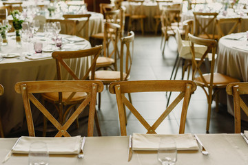 Empty lounge of a restaurant with tables, chairs and retro cutlery.