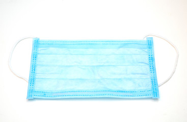 Fototapeta premium close-up of disposable blue medical face mask on white background