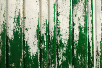 Old metal wall with peeled off paint.