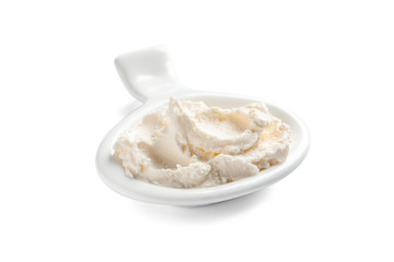 Serving spoon with tasty cream cheese on white background