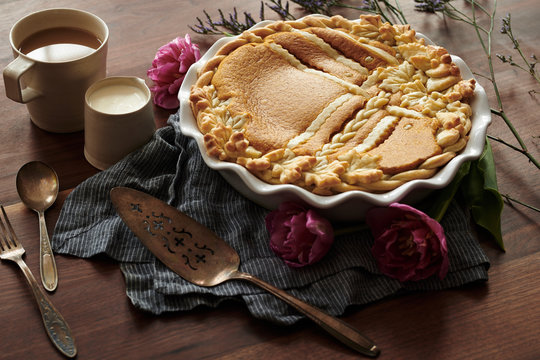 Baked Pumpkin Pie with Leaf Patterned Crust Coffee and Cream on Wood Table  Vintage Utensils 