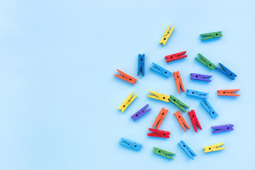 Multicolored clothespins on a blue background.