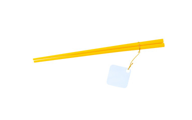 Gold or yellow wood pairs of chopsticks hanging with white paper for text or price