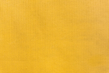 Сolored towel texture. Yellow fabric background.
