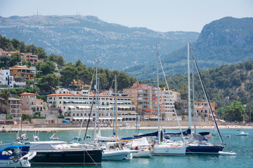 Fototapeta na wymiar Port de Soller, Mallorca, Spain - July 19, 2013: View from the sea of the city, yachts, beach, streets, hotels.