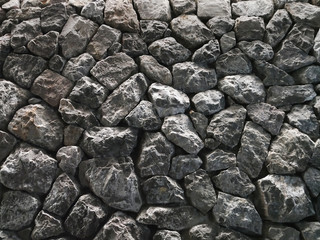 solid rocks wall under dramatical contrast light