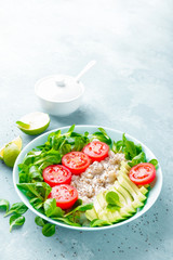 Oatmeal porridge with avocado and vegetable salad of fresh tomatoes and lettuce. Healthy dietary breakfast