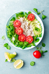 Oatmeal porridge with avocado and vegetable salad of fresh tomatoes and lettuce. Healthy dietary breakfast. Top view
