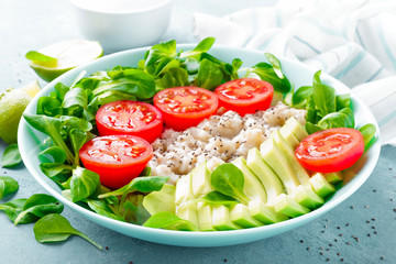 Oatmeal porridge with avocado and vegetable salad of fresh tomatoes and lettuce. Healthy dietary breakfast