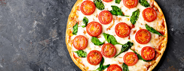 Pizza Margherita with mozzarella cheese, basil  and tomatoes Traditional italian food. Classic recipe. Top view. Banner
