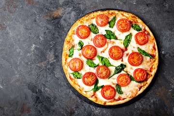 Pizza Margherita with mozzarella cheese, basil and tomatoes Traditional italian food. Classic...