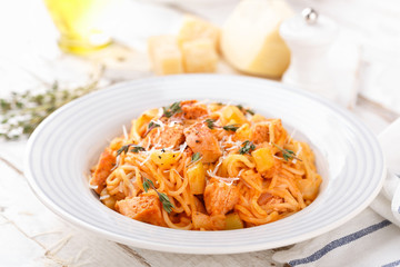 Spaghetti bolognese pasta with tomato sauce, vegetables and chicken meat on white wooden rustic background. Traditional italian food