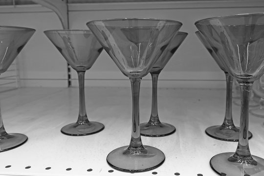 black and white transparent glasses for alcohol on the shelf......