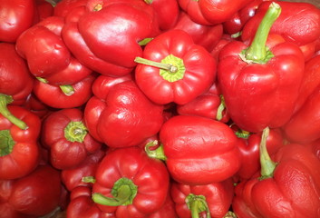 a bunch of ripe fresh peppers on the counter in the store