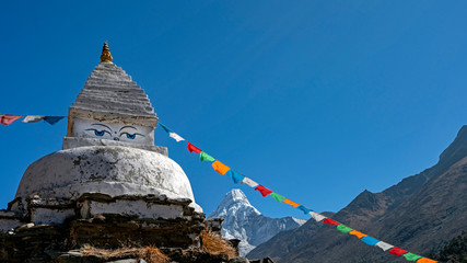 The iconic peak of Ama Dablam and a chorten of one of the main monasteries in Khumbu region in high Himalayas.