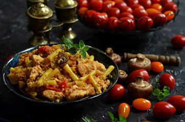 Porridge with fried chicken on a black background