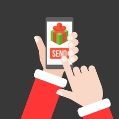 Obraz premium Santa claus hand send gift from smartphone