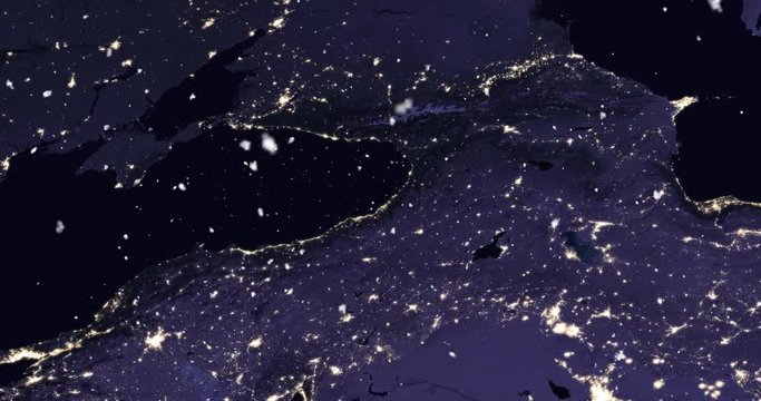 Vertical aerial ascent through light falling snow, over the Baltics, at night. Elements of this image furnished by NASA. 