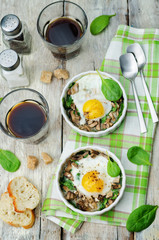 Spinach mushrooms baked egg on a wood background