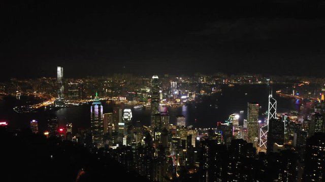 rising aerial of hong kong at night with text on IFC building