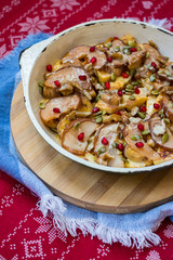 Baked fruits baked in cast iron skillet pan with apples, pears, pomegranate grains, bananas, nuts, pumpkin seeds, natural honey.