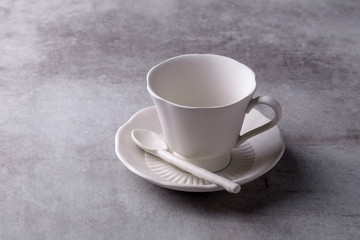 Obraz na płótnie Canvas Teapot creamer, Cup and saucer on Cement Board
