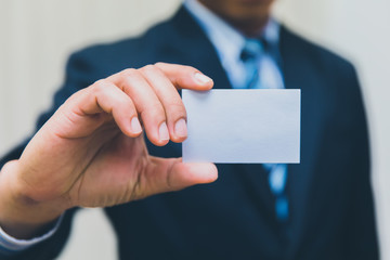 Businessman showing business card in suit