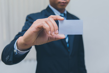 Businessman showing business card in suit