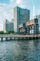 Naklejka premium Long Island sign and modern buildings at Gantry Plaza State Park, in Long Island City, Queens, New York