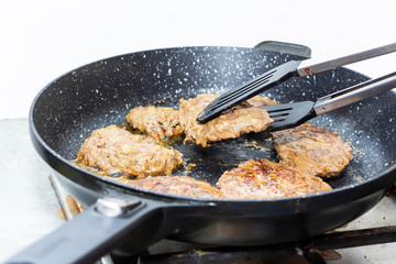 big and juicy cutlet on a metal stand. Home kitchen