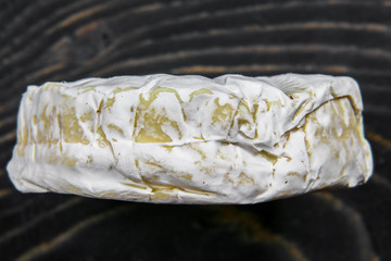 macro cheese camembert or brie close up texture on wooden background. Milk production. top view image with copy space. Food background. copy text menu