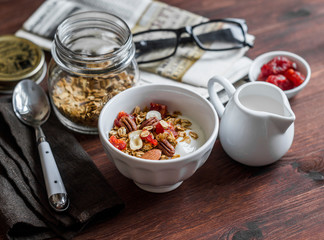 Morning breakfast table - greek yogurt with homemade granola on a dark background. Flat lay