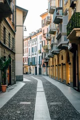 Fotobehang A cobblestone street and colorful buildings in Brera, Milan © jonbilous