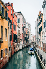 Fototapeta na wymiar Colorful pastel buildings along a canal in Venice, Italy